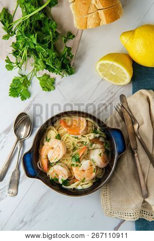 Shrimp Scampi With Angel Hair Pasta Surrounded By Cooking Ingredients