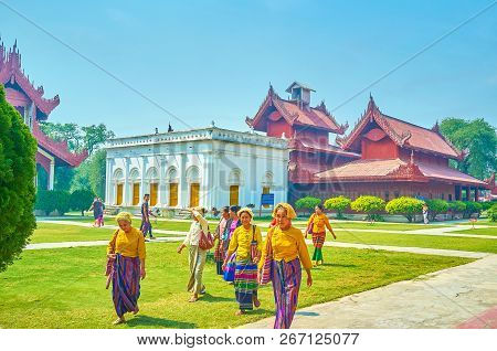 Mandalay, Myanmar - February 23 ,2018: The Group Of Burmese Tourists In Traditional Costumes Walk On