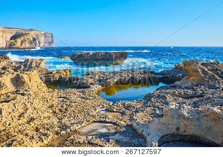 The Beauty Of Rocky Landscape Of San Lawrenz Coastline With Tall Cliffs, Tiny Natural Pools And Boul