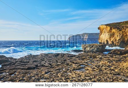 Indented Coastline Of San Lawrenz With Tall Rocky Cliffs, Former Azure Window Site, Boulders In Sea 