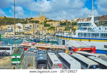 Ghajnsielem, Malta - June 15, 2018: The Ferry Terminal Of Gozo Island Is A Busy Place With Many Tour