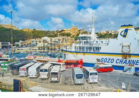 Ghajnsielem, Malta - June 15, 2018: Numerous Tourist Buses Are Parked At The Ferry Terminal Of Gozo 