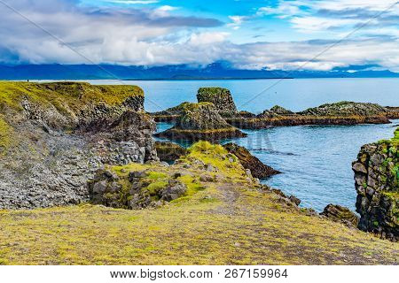 Natural Landscape Of Beautiful Mossy Cliff And Basalt Rocks Formation At Arnarstapi Village In Icela