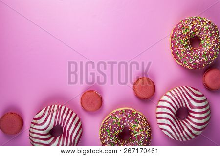 Donuts And Macaroons On A Pink Background. Delicious Desser Delicious Dessert.