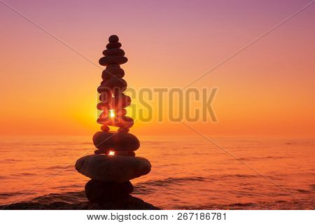 Stones Balance On A Background Of Sea Sunset. Calm And Meditation. Concept Of Harmony And Balance