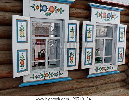 Nizhnyaya Sinyachikha,russia-aug 05,2018:the Window Architraves. The Facade Of The Hut. Folk Art (19