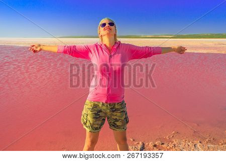 Carefree Tourist Woman With Open Arms At Pink Lake In Port Gregory, Western Australia. Blonde Caucas