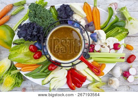 Traditional Italian Dish - Bagna Cauda. Hot Sauce And Raw Vegetables.