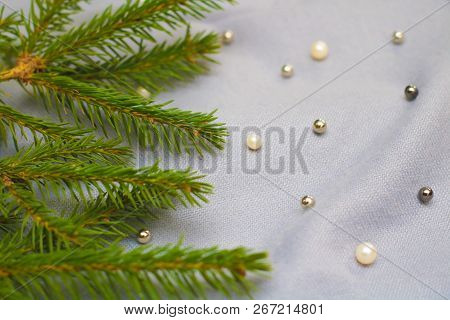 Green Branches Of Spruce With A Cozy Warm Knitted Scarf, Place For Text. Rustic Christmas Tree And W