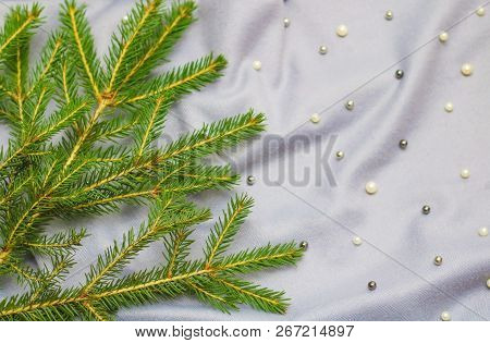 Green Branches Of Spruce With A Cozy Warm Knitted Scarf, Place For Text. Rustic Christmas Tree And W