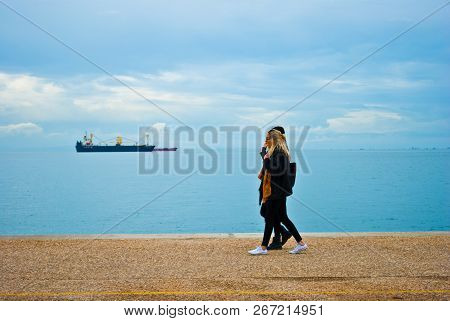 Laconic Image Of The Seascape With Beautiful Ladies Walking And The Ship Being On The Background Leo