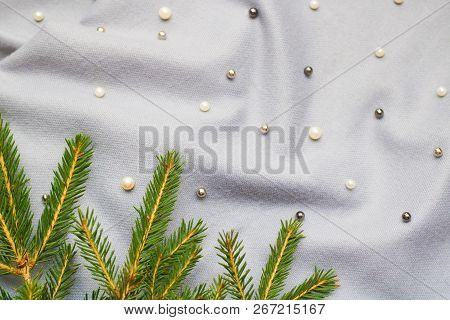 Green Branches Of Spruce With A Cozy Warm Knitted Scarf, Place For Text. Rustic Christmas Tree And W