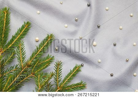 Green Branches Of Spruce With A Cozy Warm Knitted Scarf, Place For Text. Rustic Christmas Tree And W