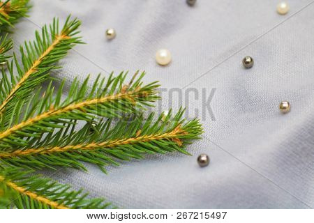 Green Branches Of Spruce With A Cozy Warm Knitted Scarf, Place For Text. Rustic Christmas Tree And W