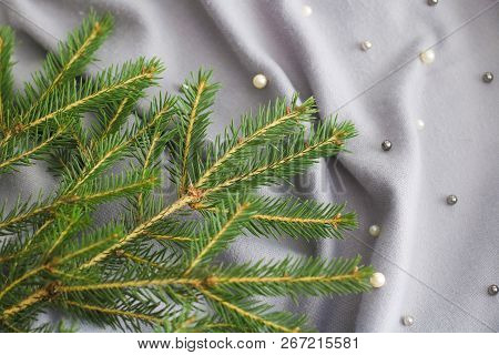 Green Branches Of Spruce With A Cozy Warm Knitted Scarf, Place For Text. Rustic Christmas Tree And W