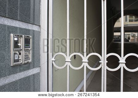 Built Into The Wall Panel Intercom With A Gate And A Prospect Of The Courtyard In The Background Wit