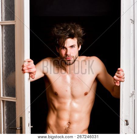 Sexy Attractive Macho Tousled Hair Coming Out Through Bedroom Door. Sexy Bachelor Lover Concept. Guy