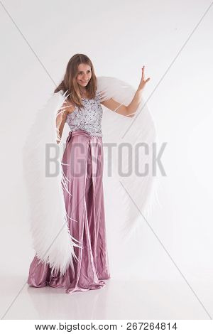 Girl In Pink Dress With Angel Wings On White Background. Angel-woman
