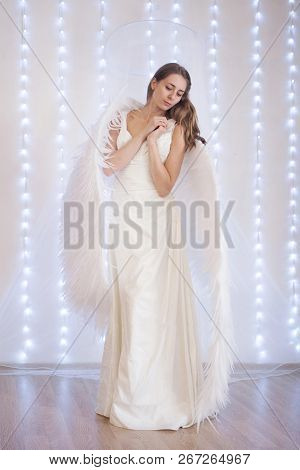 Girl In White Dress With Angel Wings On White Background. Angel-woman