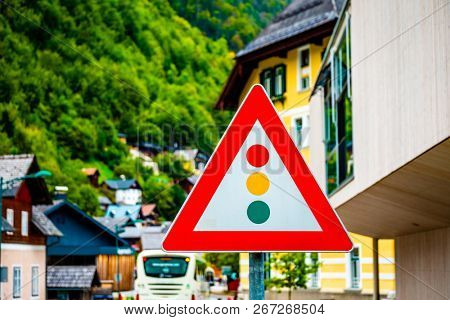 Bright road traffic light regulation warning sign on the steet
