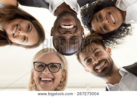 Low Angle Shot Of Excited Work Employees Standing In Circle