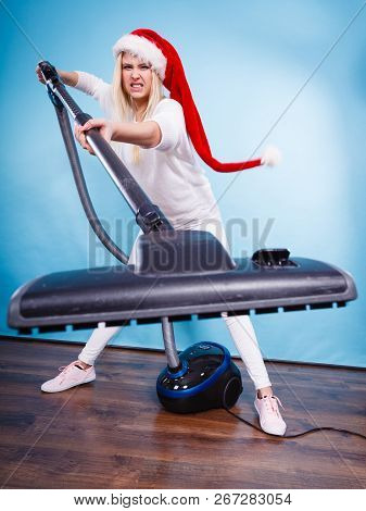 Woman Vacuuming The House, Last Minute. Teen Girl In Santa Helper Hat With Vacuum Cleaner, Angry Fur
