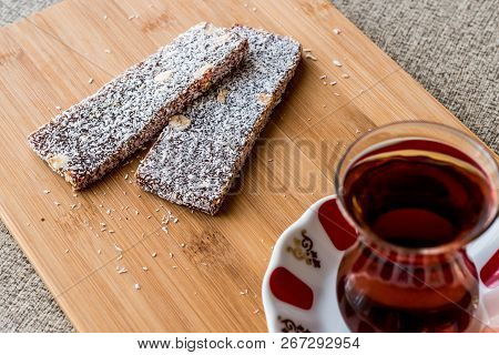 Turkish Dessert Cezerye With Walnut, Coconut Powder And Tea. Organic Food.