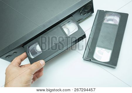 Vhs Videocassette Is Put Into The Video Recorder To Watch The Video, Another Video Cassette Is On Th