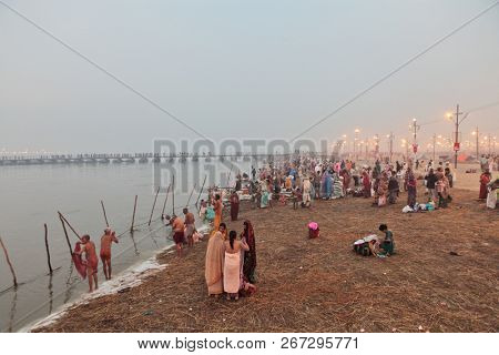 ALLAHABAD, INDIA - FEBRUARY 10, 2013: Thousands of Hindu devotees come to confluence of the Ganges and Yamuna River for holy dip during the festival Kumbh Mela. The world's largest religious gathering