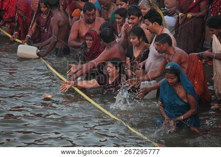 ALLAHABAD, INDIA - FEBRUARY 12, 2013: Thousands of Hindu devotees come to confluence of the Ganges and Yamuna River for holy dip during the festival Kumbh Mela. The world's largest religious gathering