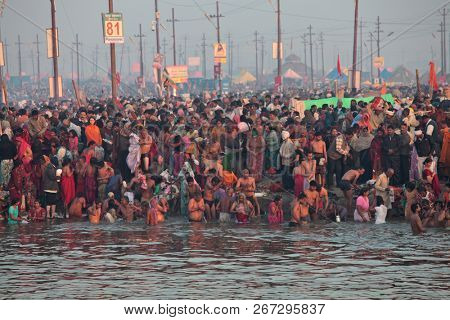 ALLAHABAD, INDIA - FEBRUARY 12, 2013: Thousands of Hindu devotees come to confluence of the Ganges and Yamuna River for holy dip during the festival Kumbh Mela. The world's largest religious gathering