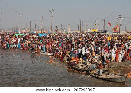 ALLAHABAD, INDIA - FEBRUARY 12, 2013: Thousands of Hindu devotees come to confluence of the Ganges and Yamuna River for holy dip during the festival Kumbh Mela. The world's largest religious gathering
