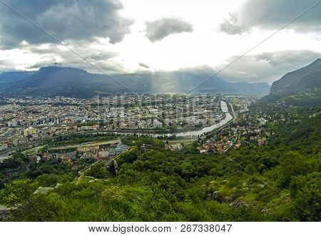 Panoramic Aerial View Of Grenoble City, France. Cloudy Sky