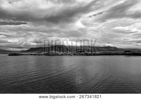Sea Water At Mountain Coast Under Cloudy Sky In Rejkjavik, Iceland. Sea On Mountain Landscape. Beaut
