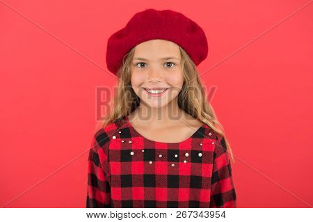 Kid Little Cute Girl Smiling Face Posing In Hat Red Background. Fashionable Beret Accessory For Fema