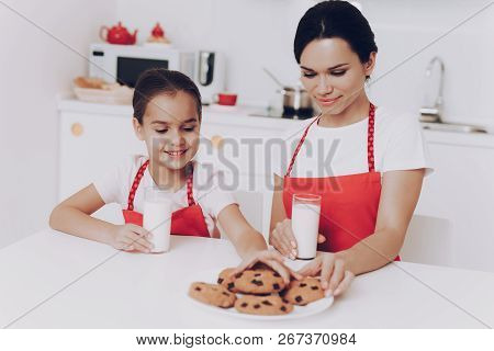 Smile Mother And Young Girl Beautiful Cake And Milk. Mom And Girl Bake A Cake Together. Happy Girl W