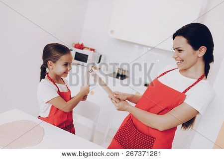 Fight With Rolling Good Time With Family. Mother With Young Girl Fight In Kitchen. Family Time Toget