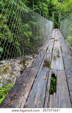 Suspension Bridge At The Hiking Trail Sendero Los Quetzales In National Park Volcan Baru During Rain