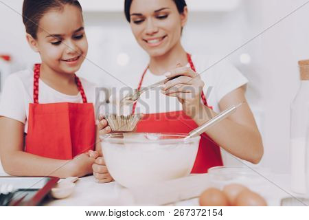 Girl Look How Cook Mother. Young Girl Help Mother With Dough. Young Daughter Preparation Dough. Swee