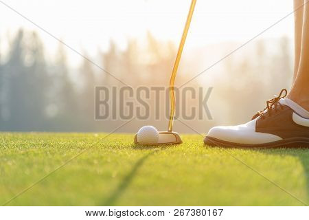 Hand Asian Woman Putting Golf Ball On Tee With Club In Golf Course On Evening  Time For Healthy Spor