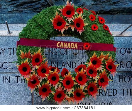 CHARLOTTETOWN, PE, CANADA - DEC. 8, 2017: A Remembrance Day wreath covered in poppies hanging on a Canadian war memorial. 