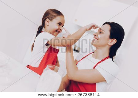 Happt Mom And Young Daughter Play Game Smudge Together. Bake Cook For Family. Game With Mother. Moth