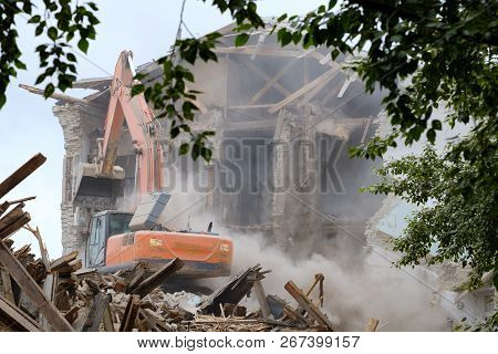 View Through The Branches Of A Tree On The Technique That Destroys The Building, The Dismantling Of 