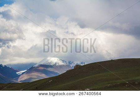 Green Hill With Snow Peaks And Coluds Background