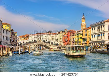 The Rialto Bridge And A Vaporetto In A Canal Of Venice
