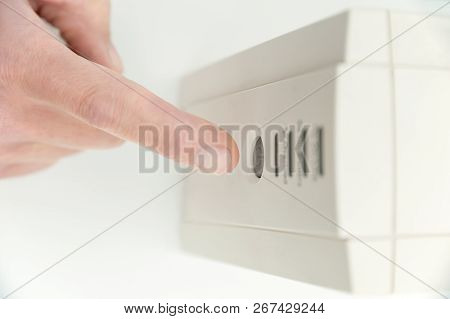The Index Finger Is Pressing On The Start Button Of The Uninterrupted Power Supply.
