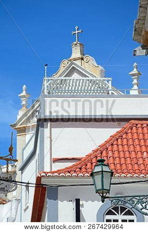 Albufeira, Portugal - June 10, 2017 - Traditional Portuguese Buildings With The Mother Church (igrej
