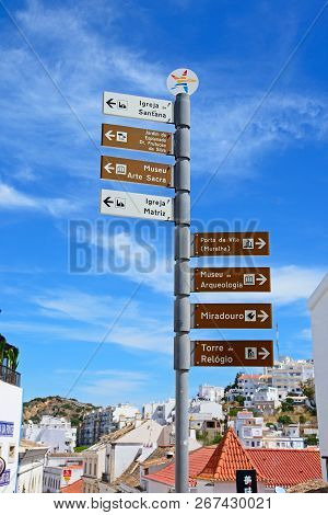 Albufeira, Portugal - June 10, 2017 - Signpost With Attractions Along Rua 5 Outubro In The Old Town,