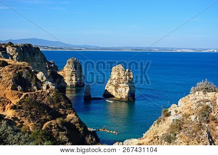 Lagos, Portugal - June 10, 2017 - Elevated View Of The Cliffs In The Ocean With Tourists In Kayaks I