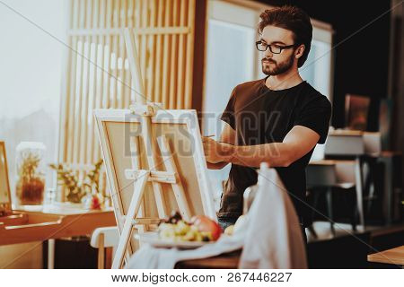 Portrait Of Guy Painting On Easel Still Life. Handsome Professional Talanted Young Painter Artist In